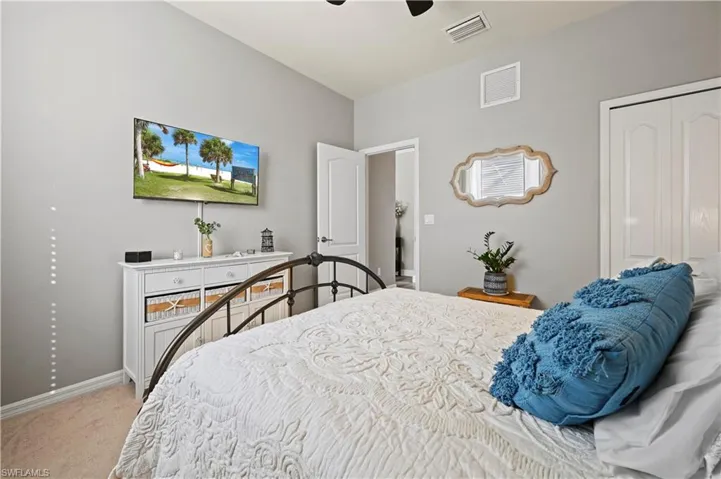 Bedroom with a closet, carpet, and ceiling fan