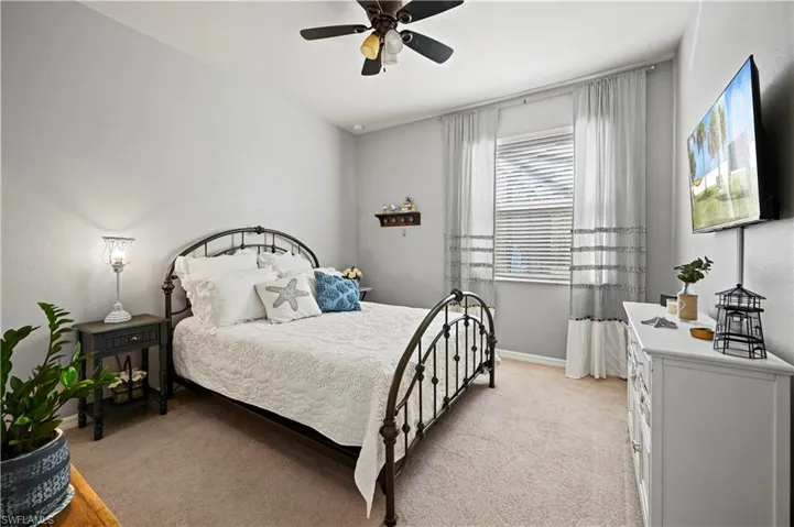 Bedroom featuring light carpet and ceiling fan