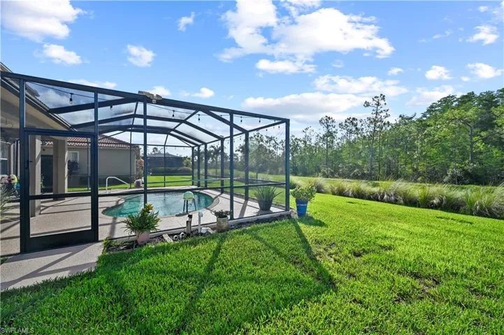 View of yard with a patio and a lanai