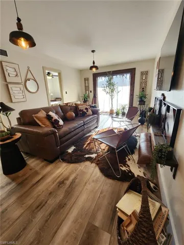 Living area featuring wood finished floors and visible vents