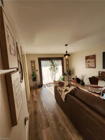 Living room featuring dark wood-style floors