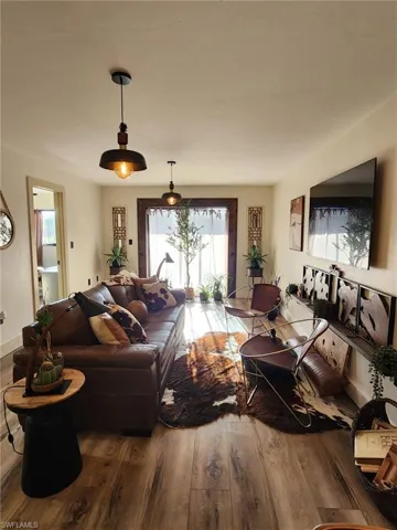 Living area featuring baseboards and wood finished floors