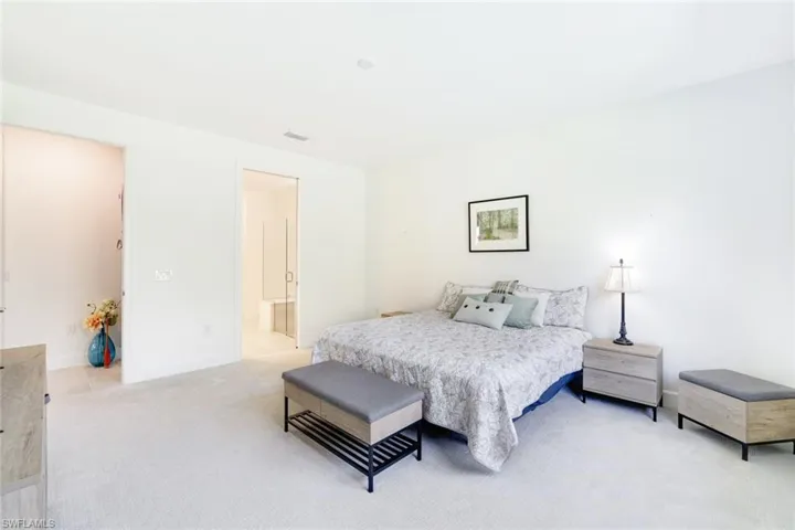 Spacious room featuring light-toned carpeting and neutral wall paint