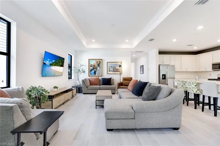 Open-concept living area featuring light wood-finish flooring and recessed lighting