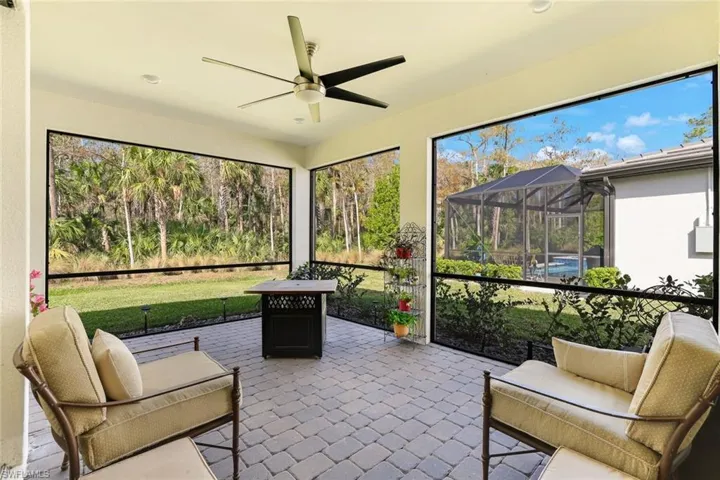 Screened patio featuring paver flooring, a ceiling fan, recessed lighting, and a screened swimming pool enclosure
