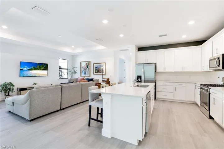 Bright open-concept interior featuring light wood-finish flooring