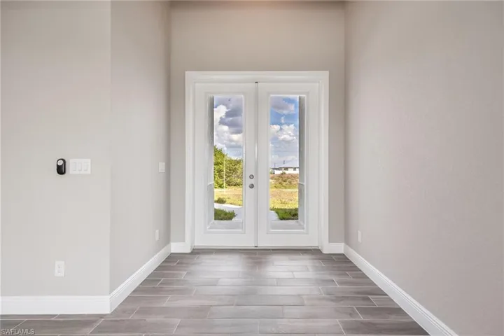 Doorway to outside with wood tiled floors and french doors-Finishes may vary