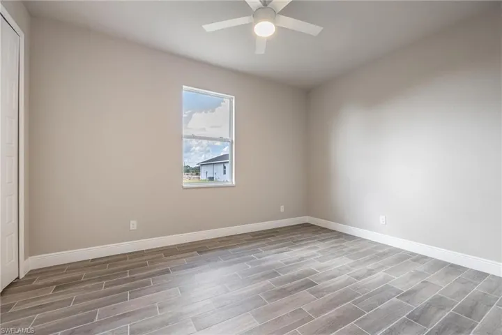 Spare room featuring baseboards and wood tiled floors-Finishes may vary