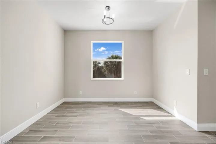 Spare room featuring wood finish floors and baseboards-Finishes may vary