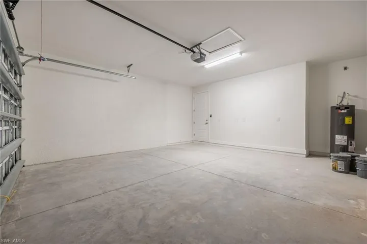 Garage with electric water heater-Finishes may vary