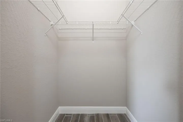 Spacious closet featuring wood finish floors-Finishes may vary