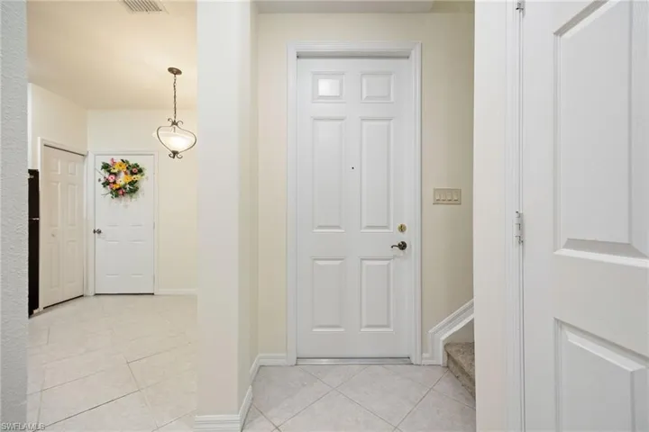 Inside looking at the front door and the left into the kitchen door to garage