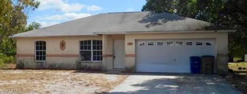 Ranch-style house featuring an attached garage and concrete driveway