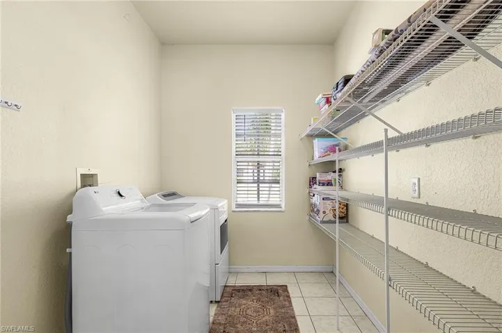 Dedicated laundry room with washer and dryer, offering convenient and functional everyday living.