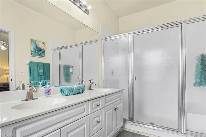 Well-appointed primary bath with double sinks, generous counter space, and a walk-in shower.