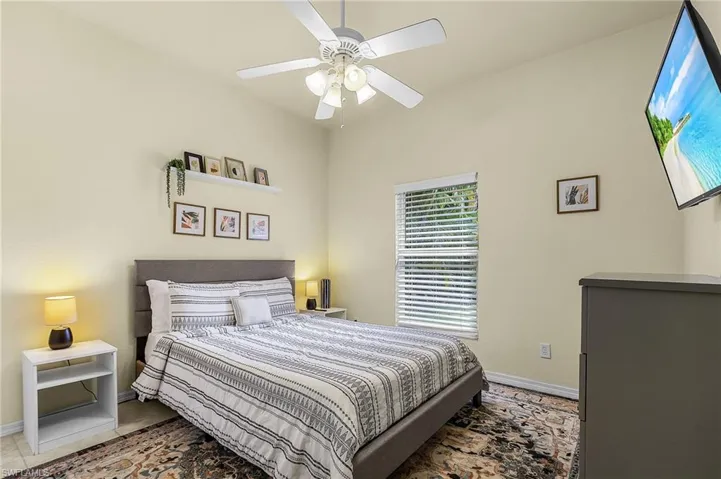 Bright and inviting bedroom featuring a well-sized layout and natural light, ideal for guests or family.