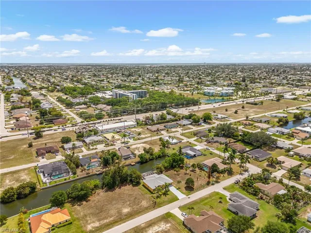 Expansive aerial highlighting the neighborhood setting and easy access to nearby conveniences.