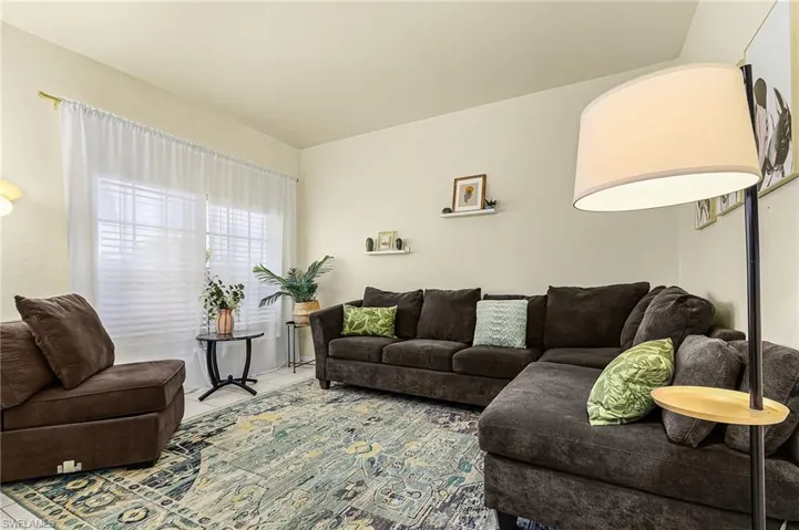 Cozy sitting room filled with natural light, offering a flexible space perfect for relaxing, reading, or additional living