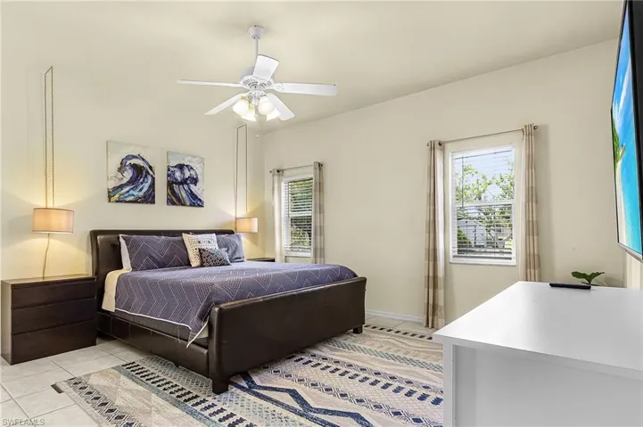 Spacious primary bedroom with abundant natural light, neutral finishes, and comfortable layout.