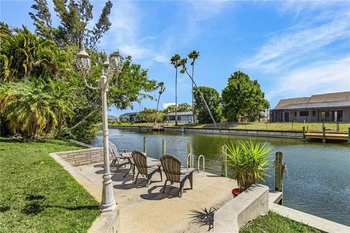 Private waterfront setting with a dock and seating area, perfect for relaxing and taking in tranquil canal views.