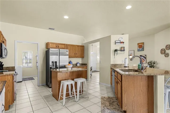 Spacious kitchen with ample cabinetry, granite countertops, and functional layout connecting seamlessly to the main living areas
