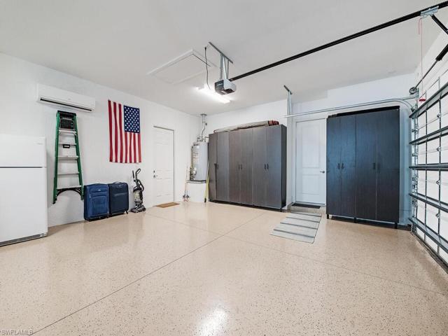 3 car garage with mini split AC and insulated doors, epoxy floor, custom cabinets to keep you organized