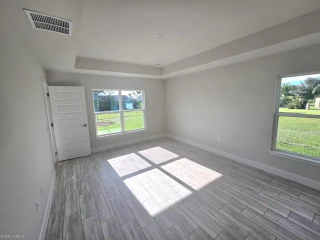 Spare room with light wood-type flooring and a wealth of natural light