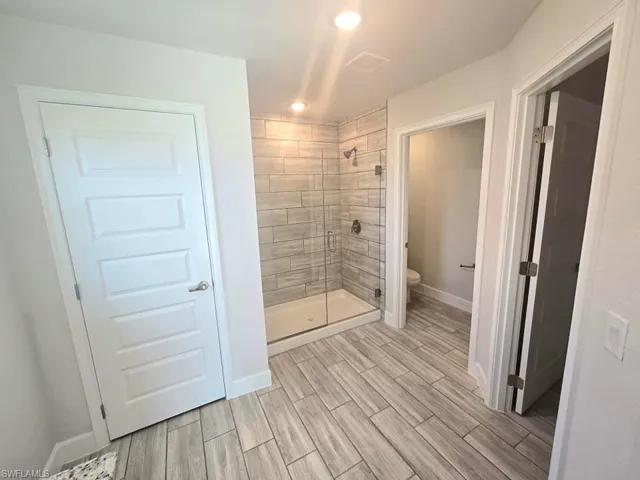 Bathroom with tiled shower and toilet