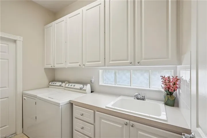 Laundry room with independent washer and dryer and cabinet space