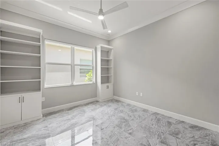 Guest bedroom with custom built in shelving so can double as a den/office if preferred