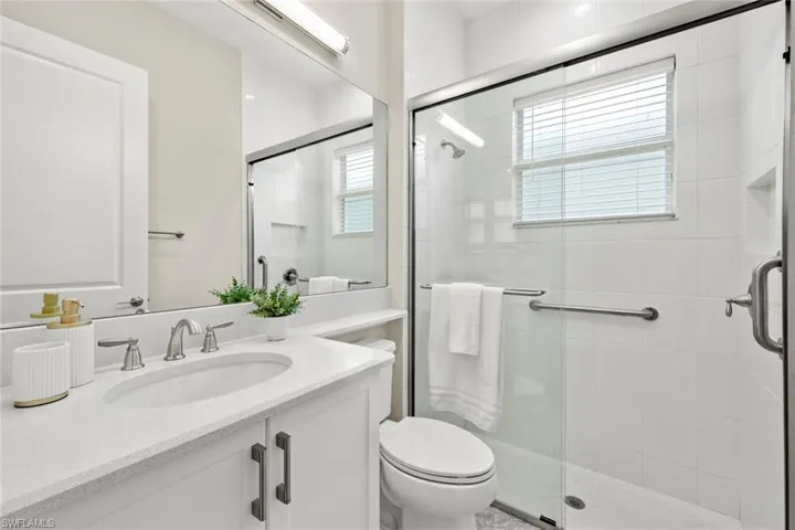 Guest bathroom with large walk-in shower, quartz counter tops