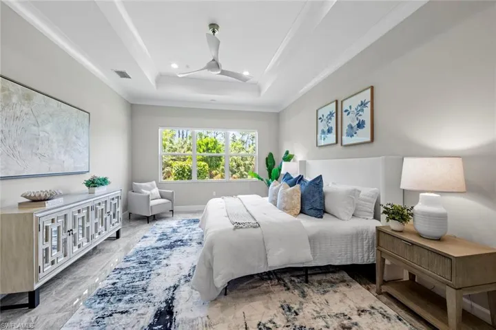 Primary with recessed lighting, a tray ceiling and ornamental molding