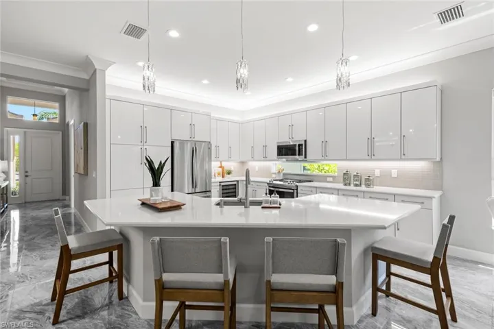 Kitchen with a sink, stainless steel appliances, marble finish tile floor flooring