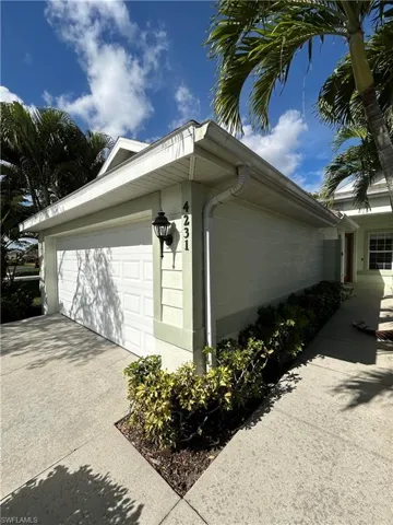 View of side of property featuring driveway