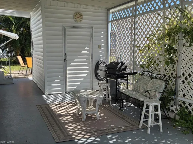 Carport with shed for extra storage.