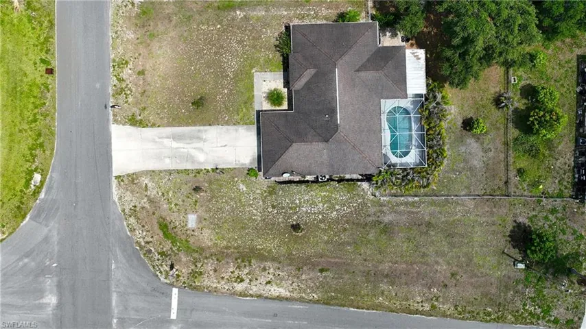 The property features a private swimming pool with a screened enclosure