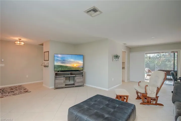 Living room featuring light tile patterned flooring and baseboards