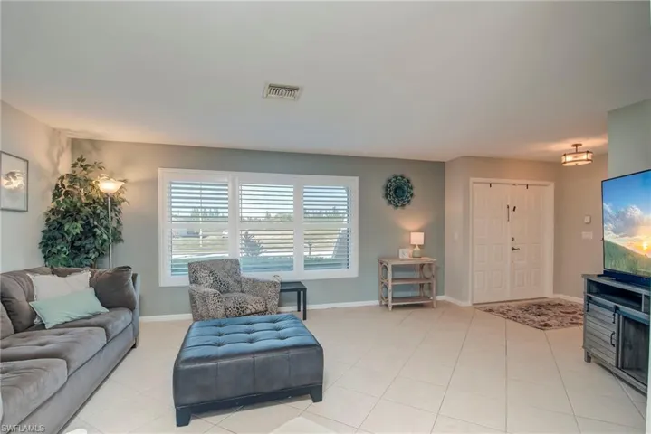 Living room with light tile patterned floors and baseboards