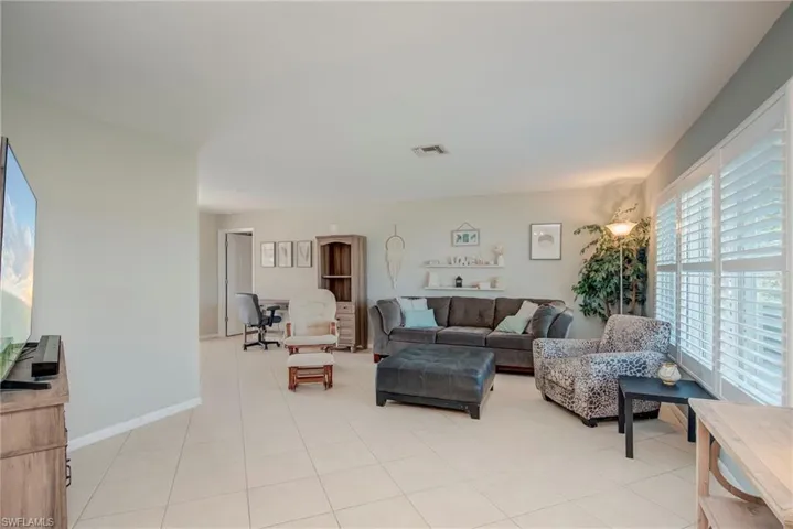 Living room featuring baseboards and light tile patterned flooring