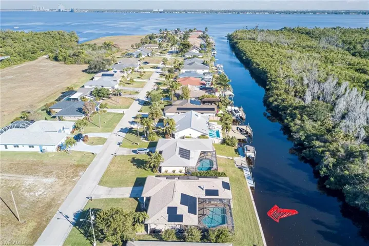 Aerial view of residential area featuring a nearby body of water