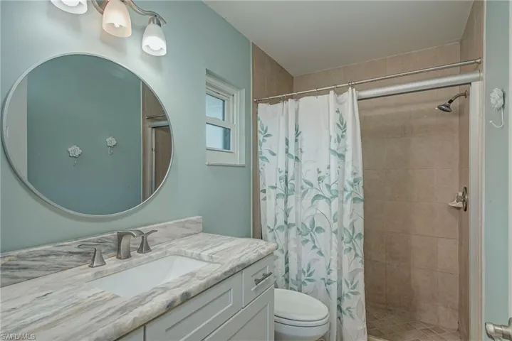 Bathroom with a shower stall and vanity
