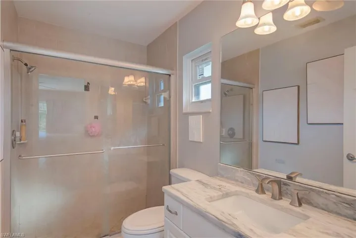 Full bathroom featuring vanity and a shower stall