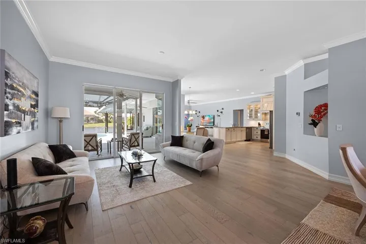 Living room featuring crown molding and light wood-style floors