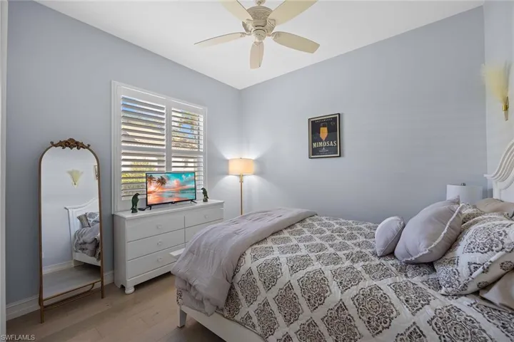 Bedroom with hardwood / wood-style floors and ceiling fan