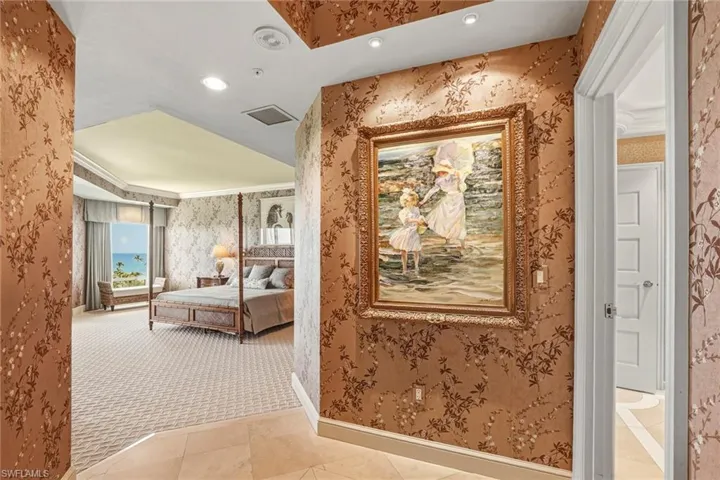 Hallway with recessed lighting, light tile patterned floors, wallpapered walls, crown molding, and light carpet