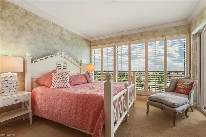 Bedroom with carpet, ornamental molding, and wallpapered walls