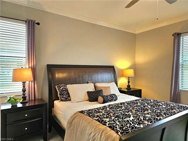 Bedroom with ceiling fan and crown molding