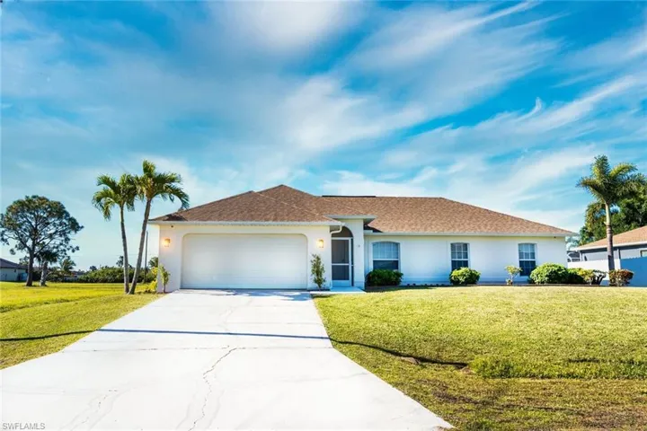Ranch-style home featuring a garage, a front lawn, stucco siding, concrete driveway, and a shingled roof