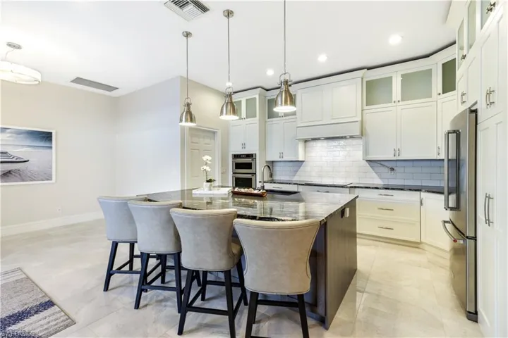 Oversized Island, tiled backsplash, tasteful granite tops