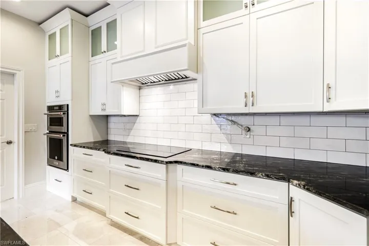 Powerful overhead exhaust fan, smooth cooktop, and BUILT in Wall Oven and Microwave